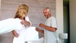 Video: Mature couple having a pillow fight and laughing Mature couple having a pillow fight and laughing