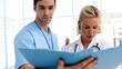 Doctors analysing a folder