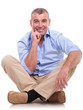 casual middle aged man sits pensive