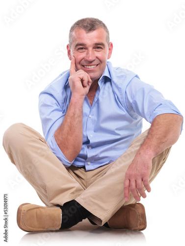 Photo: casual middle aged man sits pensive casual middle aged man sits pensive