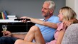 Mature couple watching television in the living room