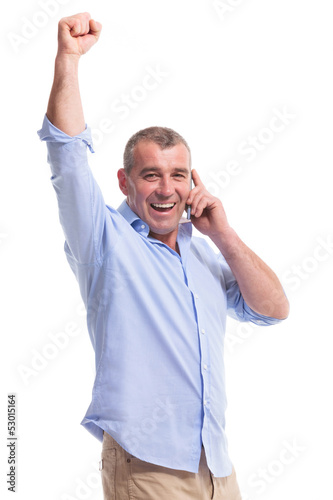 Photo: casual middle aged man on phone and cheering casual middle aged man on phone and cheering