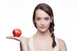 Beautiful brunette holding red apple.