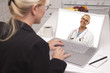 Woman In Kitchen Using Laptop - Online with Nurse or Doctor