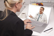 Photo: Woman In Kitchen Using Laptop - Online with Nurse or Doctor Woman In Kitchen Using Laptop - Online with Nurse or Doctor