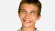 Little boy squinting against white background