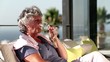 Mature woman enjoying glass of wine on balcony