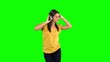 Woman dancing with headphones on green screen