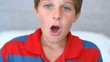 Surprised blue eyed boy opening his mouth