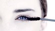 Woman making up her eye with mascara