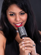 Foto: Young Woman Singing In Microphone Young Woman Singing In Microphone