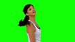 Athletic woman tossing her hair against green screen