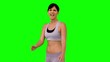 Athletic woman making marital arts pose on green screen