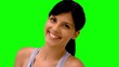 Athletic woman smiling at camera on green screen