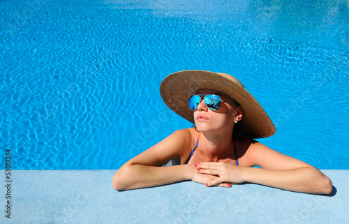 Photo: Woman at poolside Woman at poolside