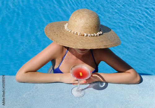 Photo: Woman at poolside with cosmopolitan cocktail Woman at poolside with cosmopolitan cocktail