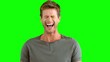 Handsome man laughing on green screen