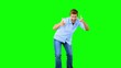Man skating and pointing at camera on green screen