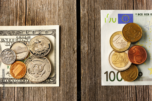 Photo: US and euro money over wooden background US and euro money over wooden background
