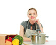 Photo: Woman in apron sitting on the desk with grocery bag Woman in apron sitting on the desk with grocery bag