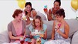 Video: Woman blowing out the birthday candles surrounded by her friends Woman blowing out the birthday candles surrounded by her friends