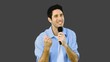 Man singing into microphone with emotion