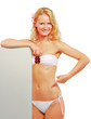 A young woman in a swimsuit with a blank, isolated on white