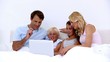 Cute family using laptop together