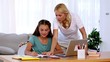 Mother helping her daughter with homework