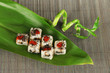 Tasty Maki sushi - Roll on green leaf on mat