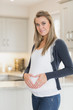Pregnant woman forming a heart with her hands