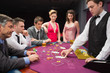 Photo: People looking at dealer dealing blackjack cards People looking at dealer dealing blackjack cards