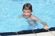 Activities on the pool. Cute boy swimming and playing in water i