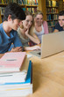 Four students studying in a library