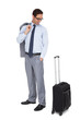 Photo: Smiling businessman looking at his suitcase Smiling businessman looking at his suitcase