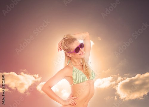 Photo: Blonde woman enjoying sunbathing in bikini Blonde woman enjoying sunbathing in bikini
