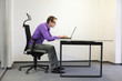 Photo: shortsighted businessman bad sitting posture at laptop shortsighted businessman bad sitting posture at laptop