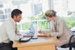 Foto: Businesswoman signing contract at interview Businesswoman signing contract at interview