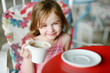 Adorable little girl drinking hot chocolate