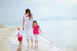 Mother and her kids walking along a beach