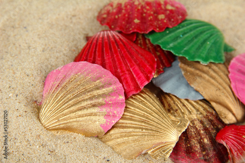 Photo: Colorful seashells on sand background Colorful seashells on sand background