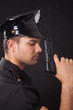 Young policeman looking down