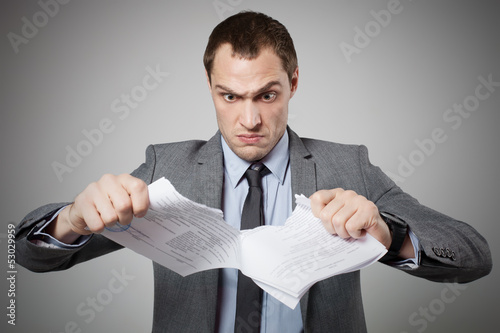 Photo: Businessman tearing contract Businessman tearing contract