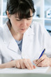 Photo: Scientist or a medical student writing Scientist or a medical student writing