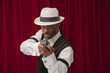 African American male in retro mobster suit holding a gun