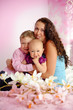 Happy family mother and her children boy and girl sitting indoor