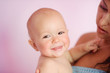 Close up of adorable 1 years old baby laughing with his first to
