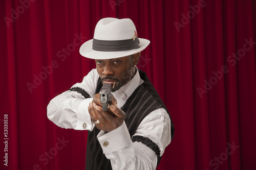 Photo: African American male in retro mobster suit holding a gun African American male in retro mobster suit holding a gun