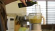Blending Asian ingredients in a food processor adding olive oil 