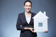 Photo: Woman with paper house Woman with paper house